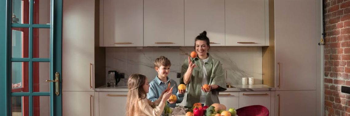 Mother with children preparing meals with fresh ingredients in a modern kitchen.
